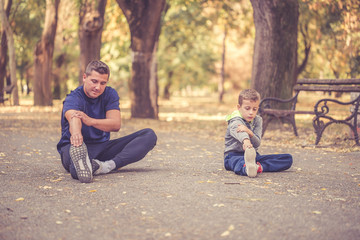Fototapeta premium Father and son exercising together outdoors