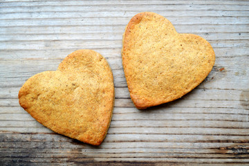 Gingerbread cookies in shape of heart on wooden table
