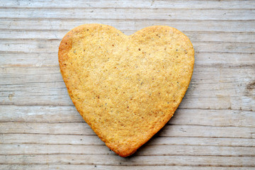 Gingerbread cookies in shape of heart on wooden table