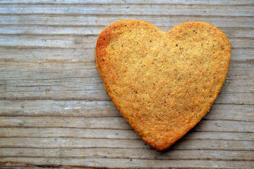 Gingerbread cookies in shape of heart on wooden table