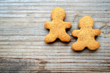 Fototapeta na wymiar Gingerbread cookies in shape of man on wooden table