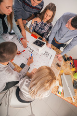 Group of young entrepreneurs plan and discuss the way the should develop their business.