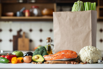 Fresh vegetables, fruits, nuts and salmon steak.