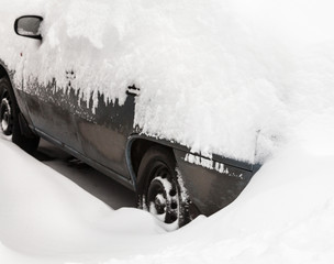 Car in the snowdrift on the parking lot