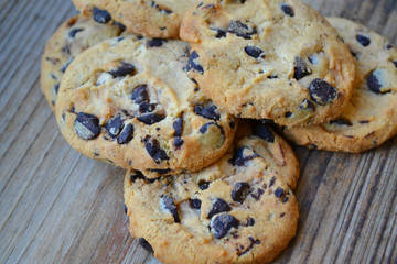 Tasty chocolate cookies on wooden table