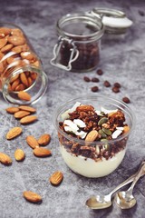 Chocolate and coffee yogurt granola in a plastic jar. Granola dessert for take away. Healthy street food granola  