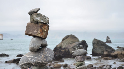balanced stone pile next to the ocean