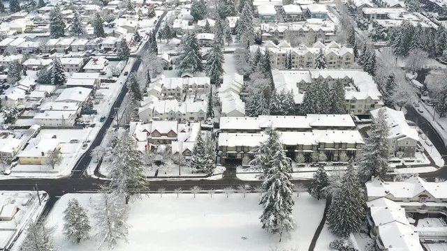 A perfect neighbourhood. Houses in suburb at Winter in the north America. Luxury houses covered nice snow. Aerial drone view. 4K.