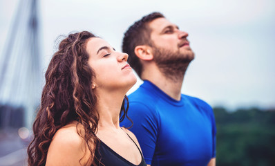 Breath a fresh air. Young couple enjoys together in the morning training outdoor. Sport, fitness,...