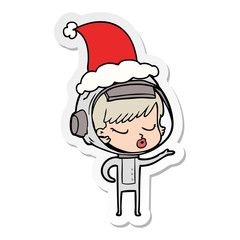 sticker cartoon of a pretty astronaut girl wearing santa hat