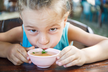 Beautiful baby boy is eating soup in Thailand