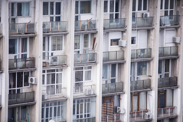 Fototapeta na wymiar Inhabited, old and neglected communist era block of flats