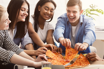 Friends eating pizza, spending time together at home