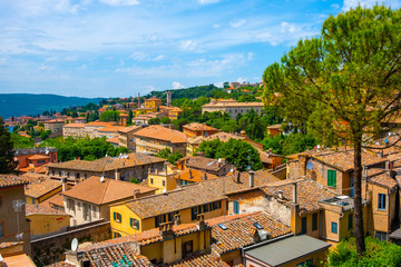 Fototapeta premium Perugia, Italy - Panoramic view of the Perugia historic quarter with medieval houses and Umbria valleys and mountains in background