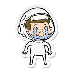 sticker of a cartoon crying astronaut