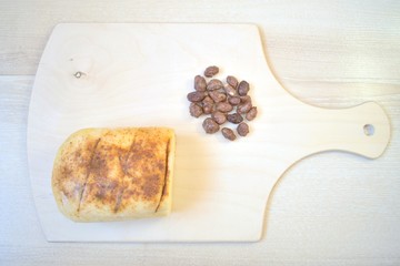 Cheese with peanuts on a chopping board