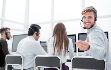 Obraz premium rear view. young customer service agent sitting at his Desk