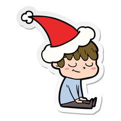 sticker cartoon of a happy boy wearing santa hat
