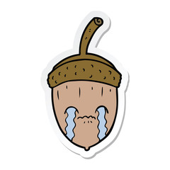 sticker of a cartoon crying acorn