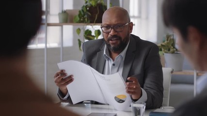 african american businessman sharing creative ideas for startup project team leader meeting with colleagues discussing corporate strategy in office boardroom