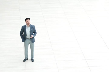 view from afar.businessman looks at the screen of the smartphone