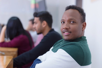 African american young university student sitting at table durin