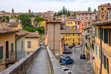 Fototapeta na wymiar Perugia, Italy - Panoramic view of the historic aqueduct forming Via dell Acquedotto pedestrian street along the ancient Via Appia street in Perugia historic quarter