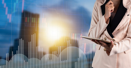 Businessman using laptop with finance and banking profit graph of stock market trade indicator...