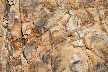 Fototapeta na wymiar Natural background with rough brown stone surface