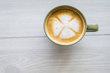 Top view cup of hot coffee on the art wooden background.