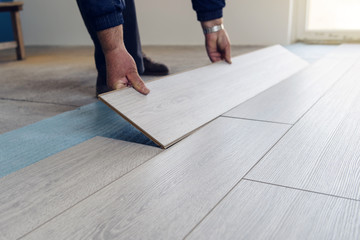 Professional Worker carpenter doing laminate floor work