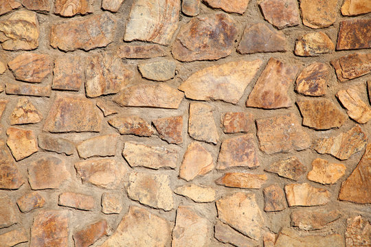 Huge rough boulders forming massive wall surface