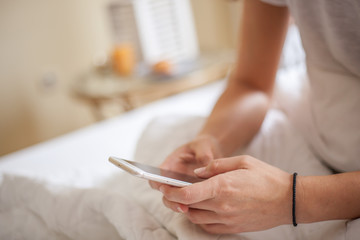 Close-up of female handholding the phone early in the morning