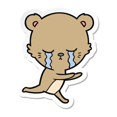 sticker of a crying cartoon bear