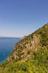 Italy, Cinque Terre, Corniglia, a close up of a hillside next to a body of water