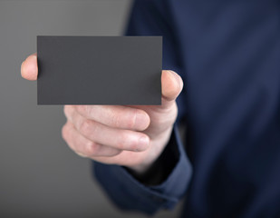 A man holding black business card