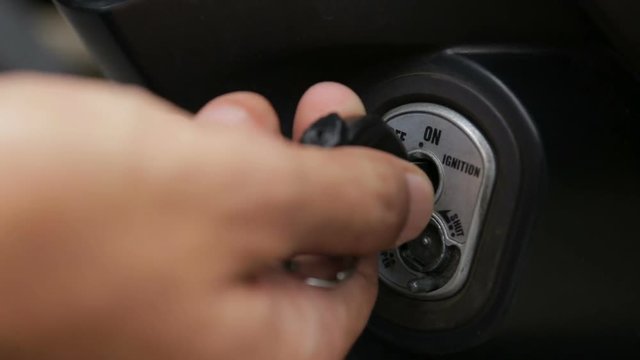 The user inserting the key and starting the engine