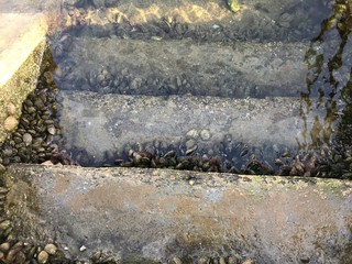 View of some stairs that descent into the oceans water and rocks on Galicia Spain