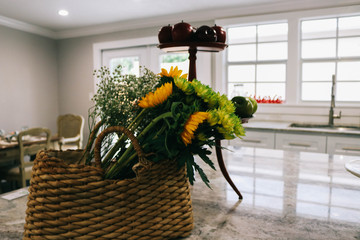 flowers in basket on table in room