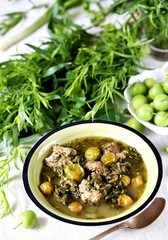 Meat stew with green plum  (tkemali) and greens. Georgian dish 
