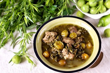 Meat stew with green plum  (tkemali) and greens. Georgian dish 