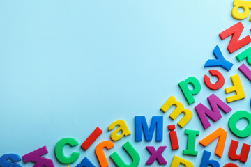 Plastic magnetic letters on color background, top view with space for text