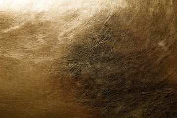 Shiny golden leather as background, top view