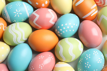 Fototapeta na wymiar Many beautiful painted Easter eggs as background, top view