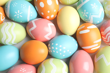 Fototapeta na wymiar Many beautiful painted Easter eggs as background, top view
