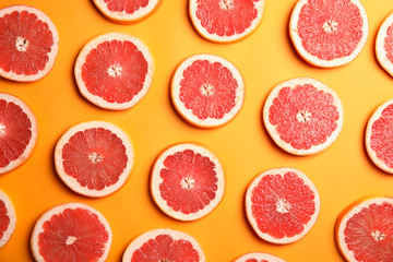 Fresh sliced ripe grapefruit on color background, flat lay