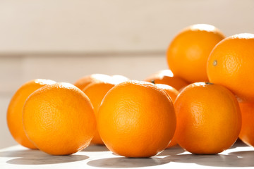 Fresh juicy oranges on table, closeup. Healthy fruits