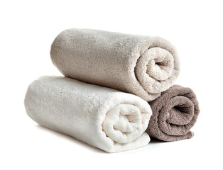 Fototapeta na wymiar Rolled soft terry towels on white background