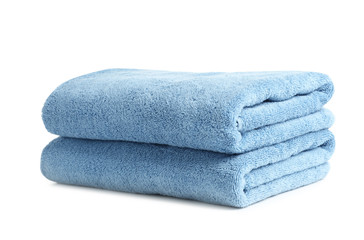 Folded clean soft towels on white background
