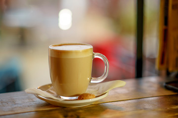Coffee Latte on wooden table and latte art made with foam